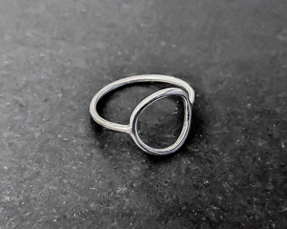 Thin sterling silver stacking ring, with a smaller circle completing the ring path