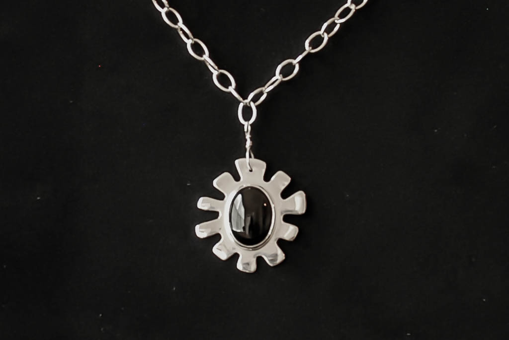 Sterling silver irregularly-shaped pendant with a black onyx stone, on a sterling silver oval cable chain