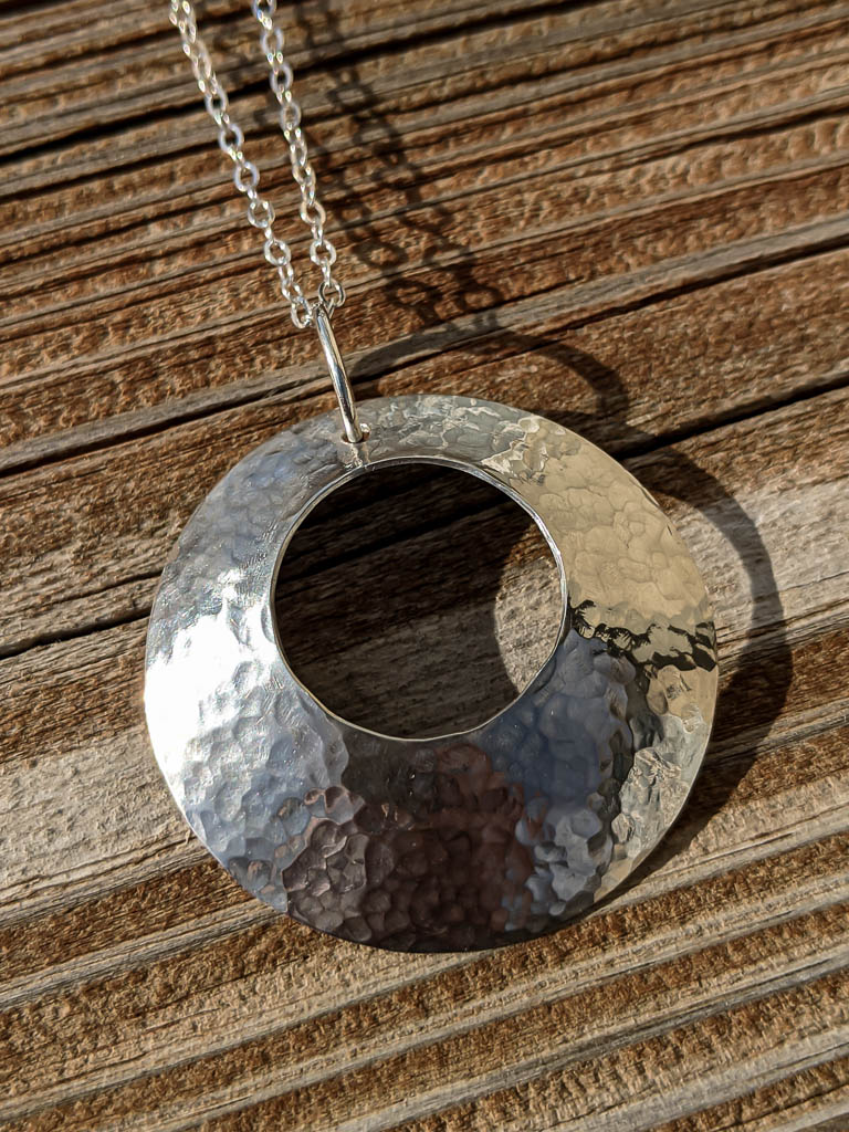 Hammered silver cutout pendant, finished with chain