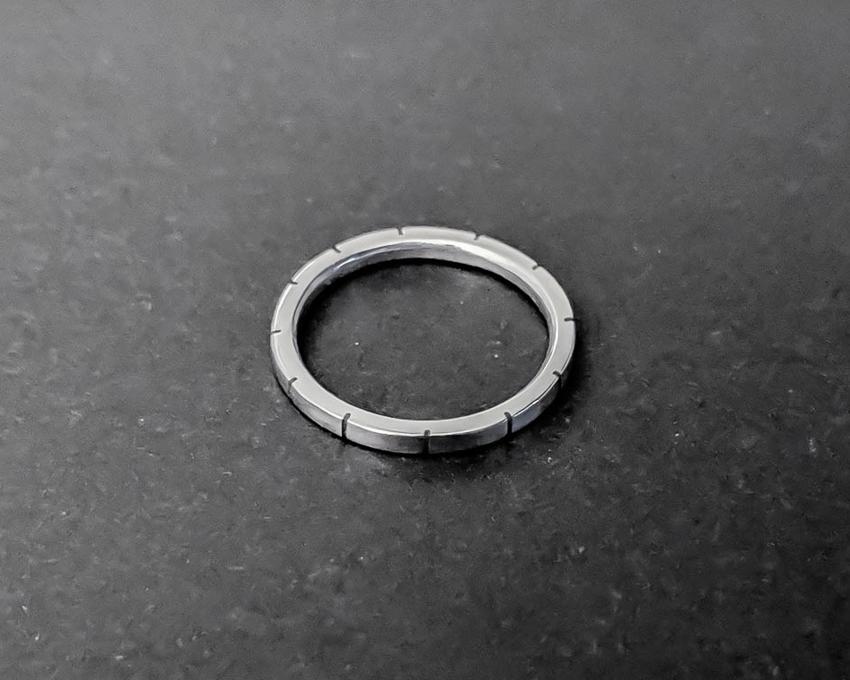 Sterling silver stacking ring with small cuts evenly spaced around its circumference